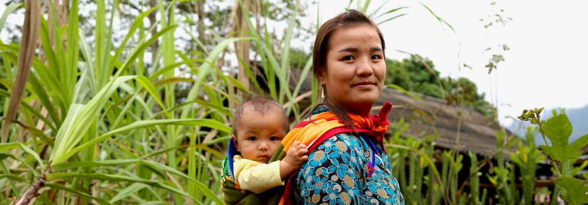 A Mother of a Save the Children Sponsored School with her Child. Image credit: SCUS