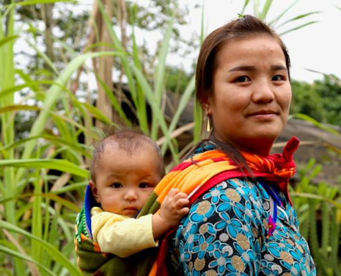 A Mother of a Save the Children Sponsored School with her Child. Image credit: SCUS