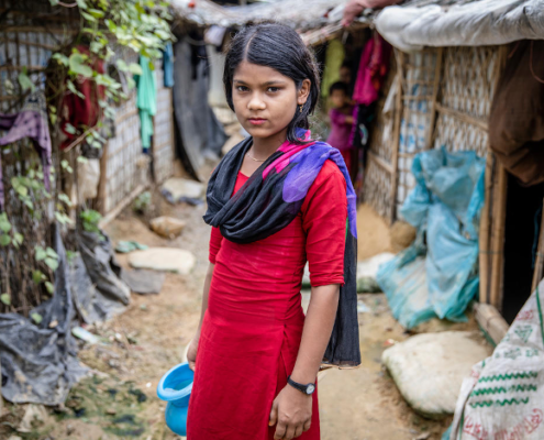 Marium*, 11, stands near her home in a camp for Rohingya Refugees in Cox’s Bazar, Bangladesh. Image credit: Jonathan Hyams / Save the Children UK Stories Team