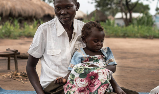 Celina* and her daughter Rose*, pose for a portrait close to Save the Children's mobile clinic in Mvepi refugee settlement. Image credit: GCCU