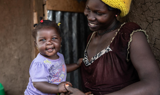 Isabella* is playing with her baby Cecilia* outside their home. Image credit: Fredrik Lerneryd / Save the Children