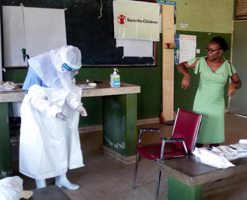 Participant health workers shown how to wear and use Personal Protective Equipment at training of health workers in Western Uganda. Image credit: Annet Kabasinguzi / Save the Children