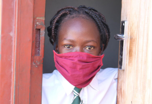 McClean, 10, with facemask, Zimbabwe. Image credit: GCCU