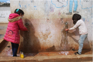 Tala* and Karma*, 9 washing their hands. Image credit: GMU