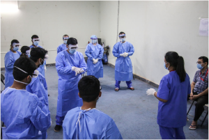 Save the Children health workers in Cox's Bazar learn how to use personal protective equipment for the COVID-19 isolation and treatment unit. Image credit: Sonali Chakma / Save the Children