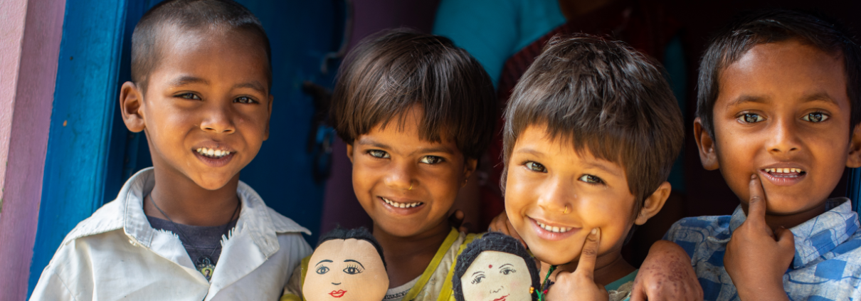 4-year-olds Krishna, left, Roshni, center left and 5-year-olds Barsha, center right, and Nitesh stand outside of their early learning center on Sunday, April 29 in Saptari, Nepal.