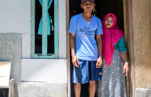 Eko (30) and Uchi (31) pose for a picture in their new house in Labean Village, Donggala, Central Sulawesi, Indonesia. Image credit: Hariandi Hafid / DEC