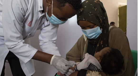 A health worker vaccinates a baby - MHC, Burao, Somalia. Image credit: Mustafa Saeed / Save the Children